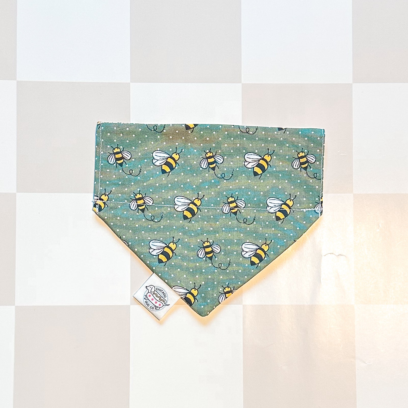 Dog bandana with bee pattern on a checkered background