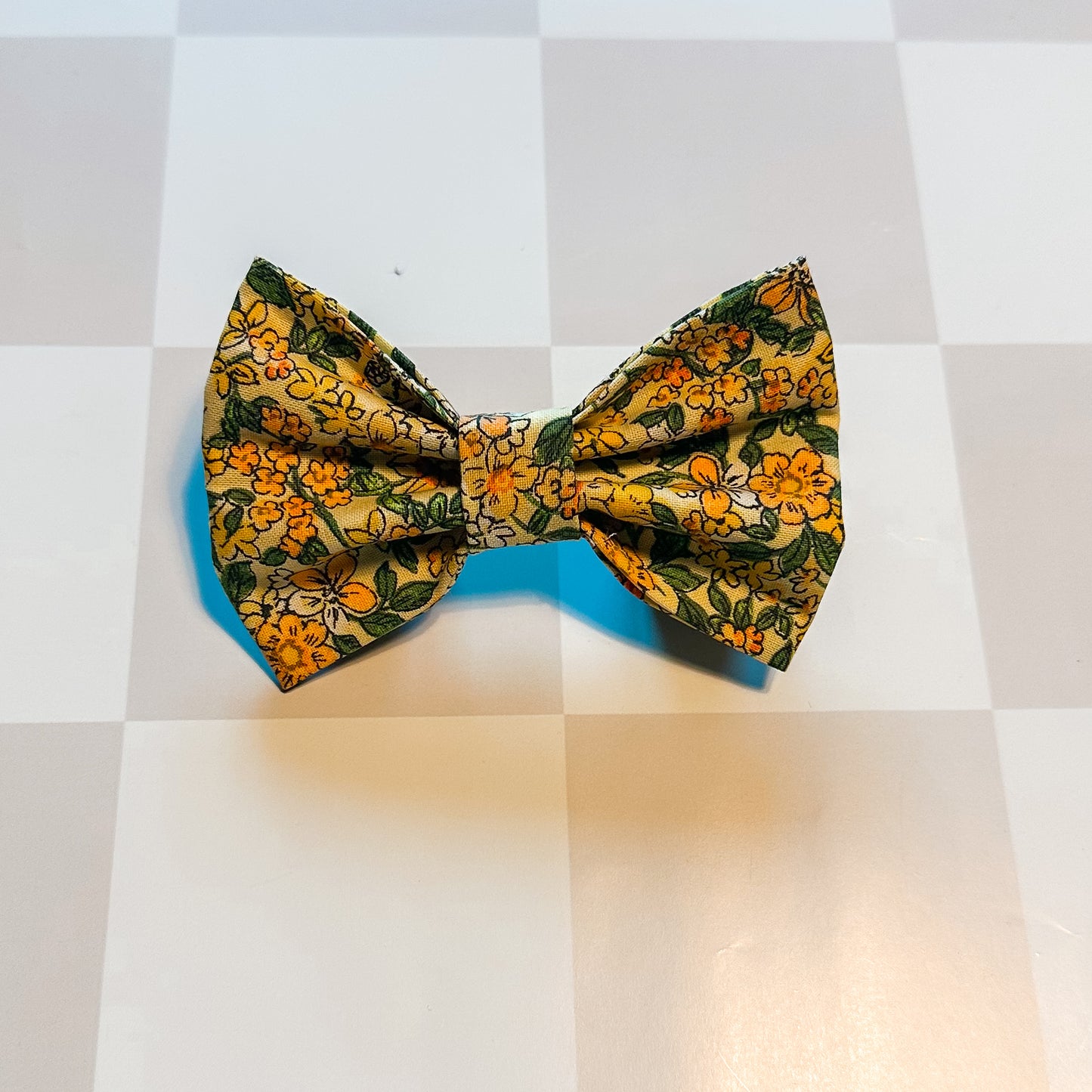 Floral patterned bow tie on a checkered background
